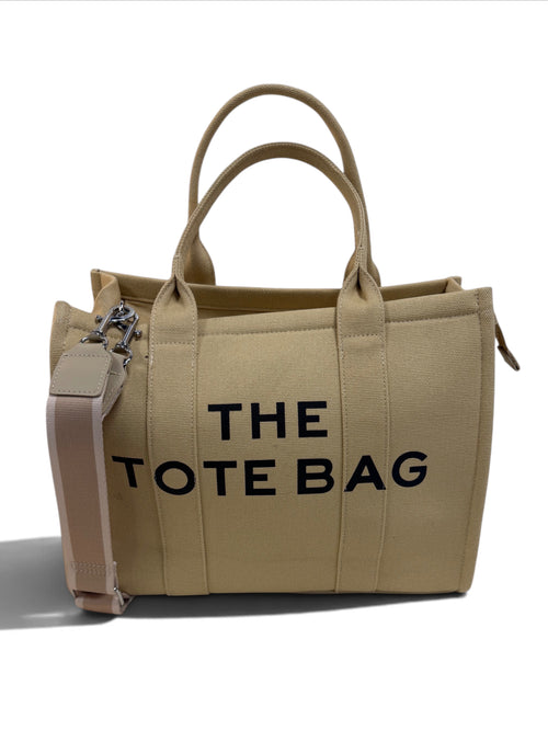 Zimoras Boutique beige canvas tote bag with black lettering, top handles, and a detachable shoulder strap.
