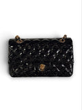Zimoras Boutique black quilted patent vegan leather shoulder bag with gold-tone chain strap and turn-lock closure.