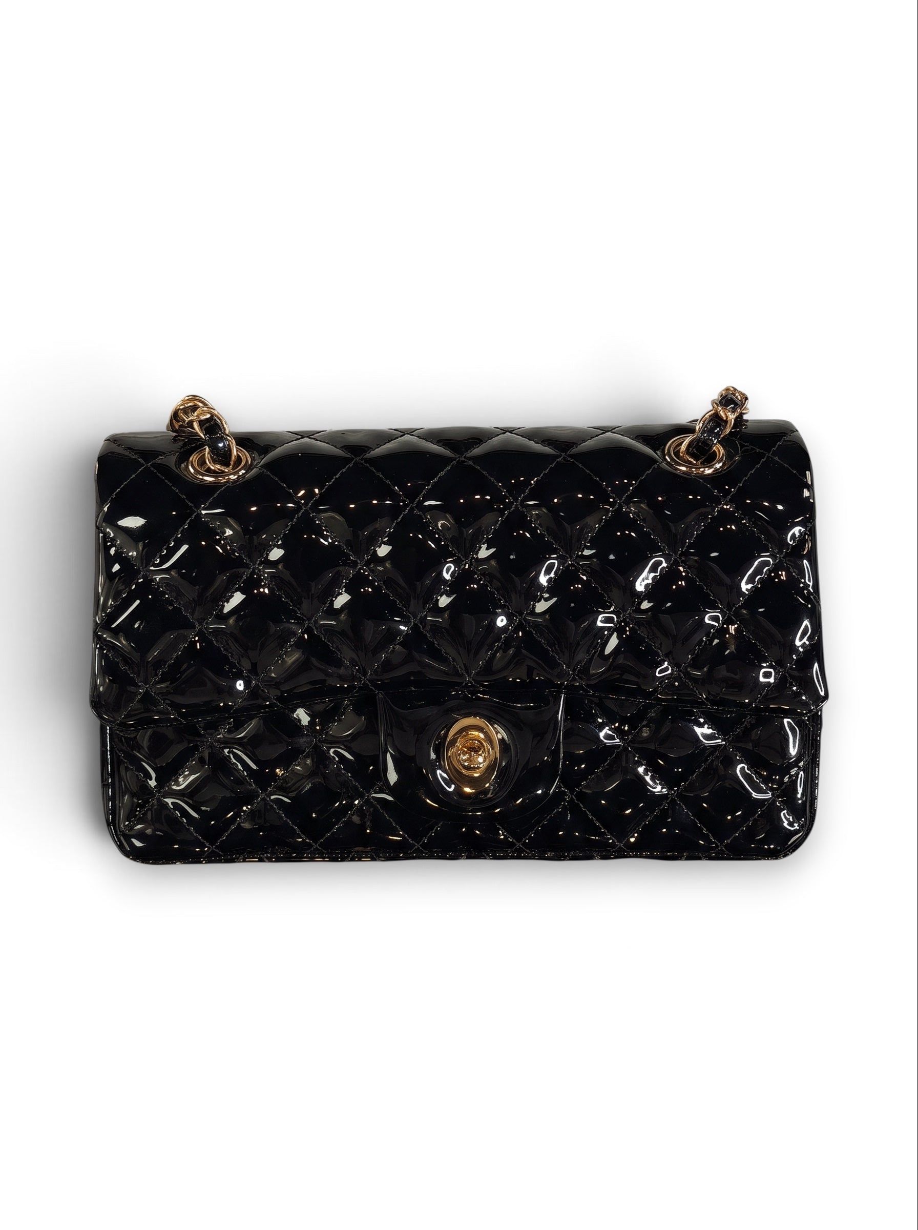 Zimoras Boutique black quilted patent vegan leather shoulder bag with gold-tone chain strap and turn-lock closure.
