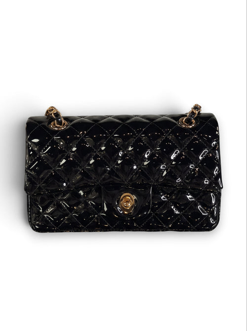 Zimoras Boutique black quilted patent vegan leather shoulder bag with gold-tone chain strap and turn-lock closure.