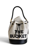 Zimoras Boutique The Bucket drawstring bag in white and black pebbled vegan leather with gold hardware